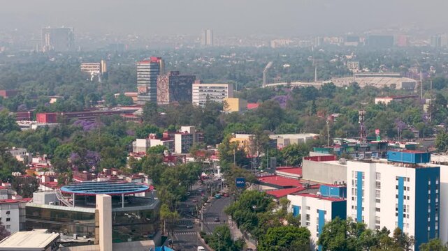 Aerial shot of south Mexico City skyline with smog and traffic