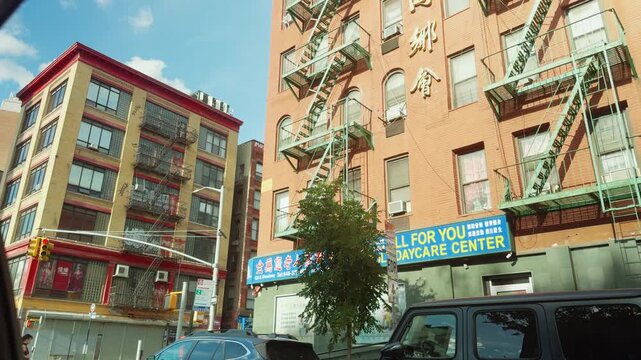 New York City Chinatown Buildings with Fire Escapes and Street Traffic