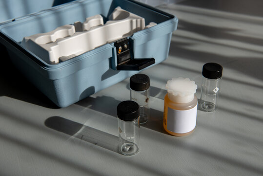Portable water testing kit with sample vials and container