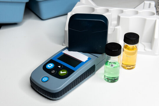 Portable water testing kit with sample vials and container