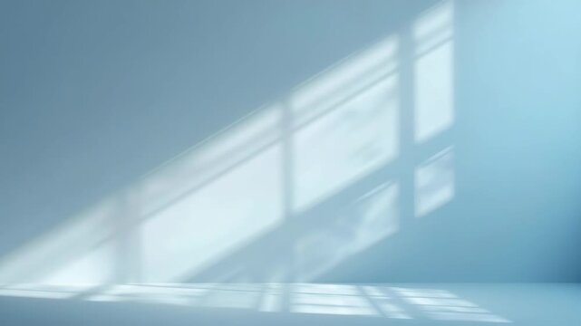Soft window light casting geometric shadow on pale blue wall and floor with serene morning glow