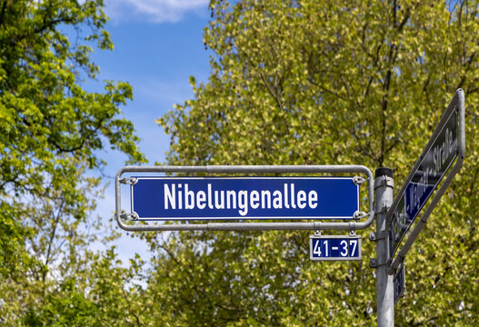 Street name Nibelungenallee - engl alley of the Nibelungen - in Frankfurt on a blue enamel sign