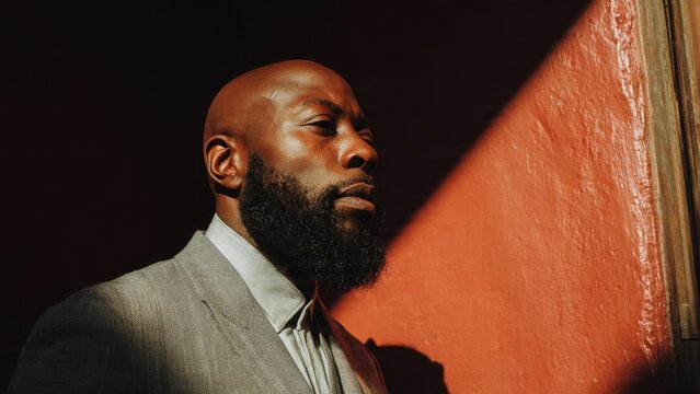 Confident Black Man in Suit with Dramatic Lighting