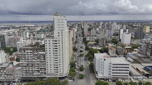 Drone flies high along main road in downtown on an overcast day in Maputo, Mozambique