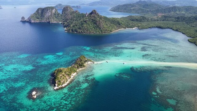 A sinuous sand bank stretches out from Snake Island in Bacuit Bay near El Nido, Philippines. This idyllic spot is a popular tourist destination and is a wonderful place to swim.