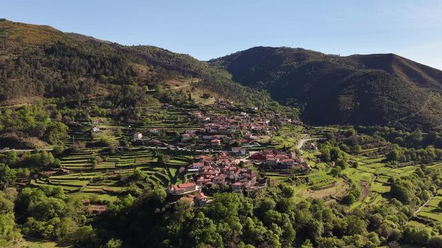 Sistelo village nestled in mountains with traditional stone houses and green terraced fields