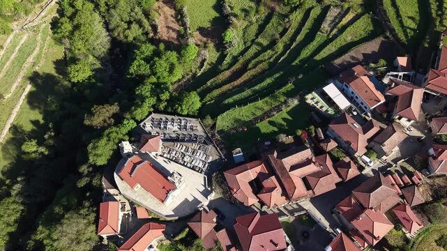 Sistelo village nestled in mountains with traditional stone houses and green terraced fields