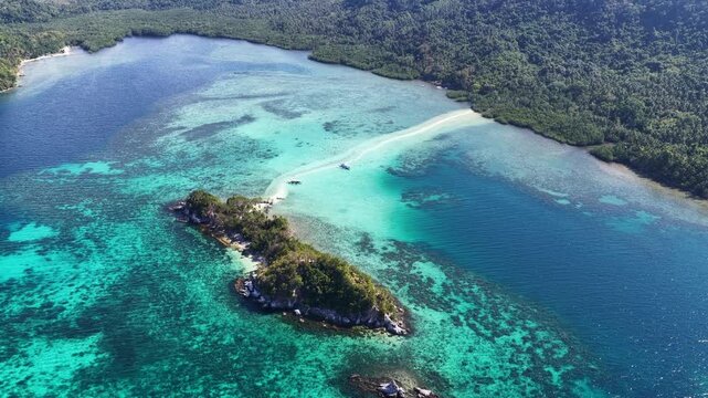 A sinuous sand bank stretches out from Snake Island in Bacuit Bay near El Nido, Philippines. This idyllic spot is a popular tourist destination and is a wonderful place to swim.