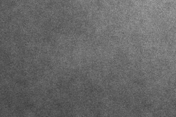 Fototapeta premium A simple dark grey grainy texture provides a subtle and versatile background.