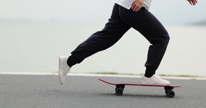Woman skateboarding at the seaside