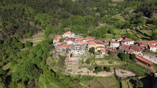 Sistelo village nestled in mountains with traditional stone houses and green terraced fields