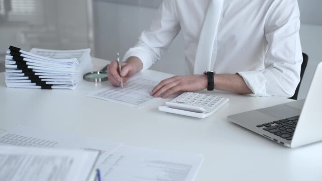 Accountant calculating tax, reviewing financial report, and managing business paperwork on a modern office desk, processing data for audit and budget planning. Audit and taxes