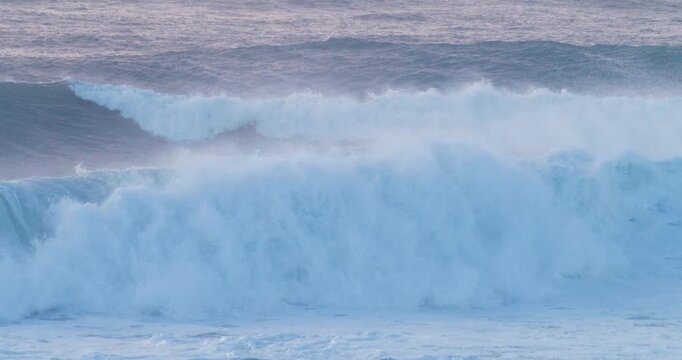 Storm driven ocean waves crashing heavy surf slow motion