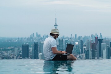Naklejka premium Man wearing hat and sunglasses working on a laptop in an infinity pool with the Toronto skyline and CN Tower in the background