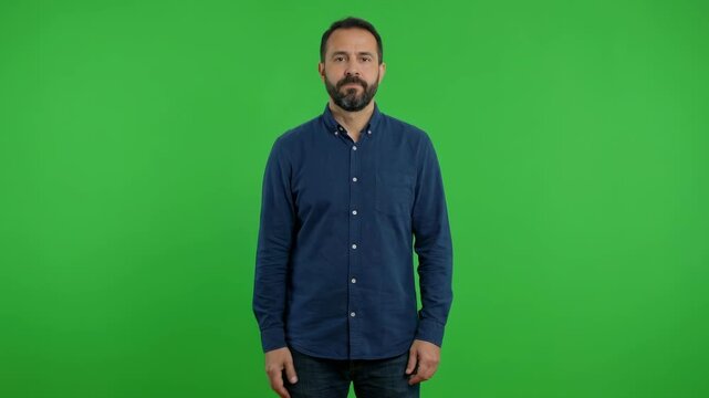 Middle aged bearded man waving hand and saying hello for greeting or introduction videos isolated on green screen chroma key background