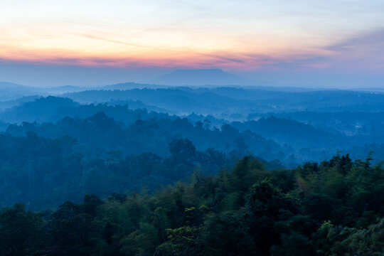 Nam Nao National Park at sunrise. Misty forest landscape in Thailand. Tropical mountains with fog during morning light.