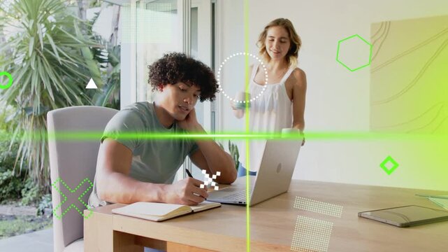 Pair in tech one writing notes on laptop, partner entering with mug pointing, green lines sweeping