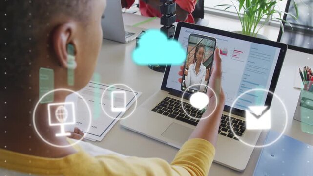 Man holding smartphone over laptop and following call, causing cloud icons animating for business