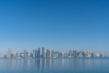 Doha Qatar West Bay Skyline Reflected in Arabian Gulf Blue Sky