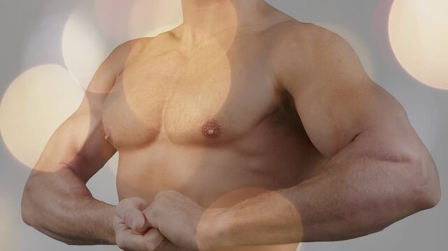 Light shifting cueing man holding chest pose as bokeh drifting over torso, showing tone for fitness