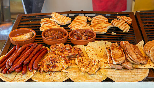 Market stall in agricultural fair with grilled meat and other meals on offer