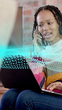 Vertical video: Woman answering phone and typing on laptop in remote work, teal wave guiding fix