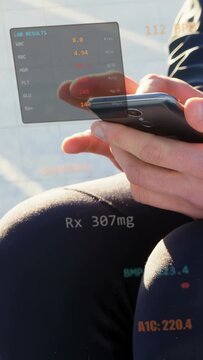 Vertical video: Adult male tapping phone on lap after HUD appearing, showing med Rx 307mg and A1C