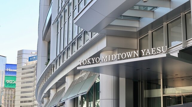 Tokyo Midtown Yaesu skyscraper entrance sign with modern architectural glass facade and metropolitan corporate city view near Tokyo Station - Tokyo, Japan, October 15, 2023