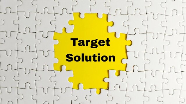 A white jigsaw puzzle features a central gap exposing a yellow background with the words "Target Solution," symbolizing strategic focus and the final step in resolving complex business challenges.