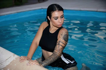Young sexy brunette sitting in the pool © Sergey Sukhorukov