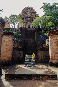 The Po Nagar Cham Towers in Nha Trang, Vietnam, are ancient Hindu temples dedicated to the goddess Po Nagar. This image captures the main tower's entrance with offerings.