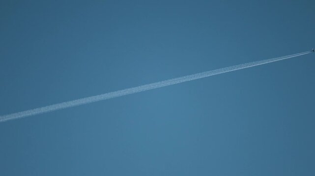 Stockholm, Sweden An airplane contrail traverses the evening sky. 
