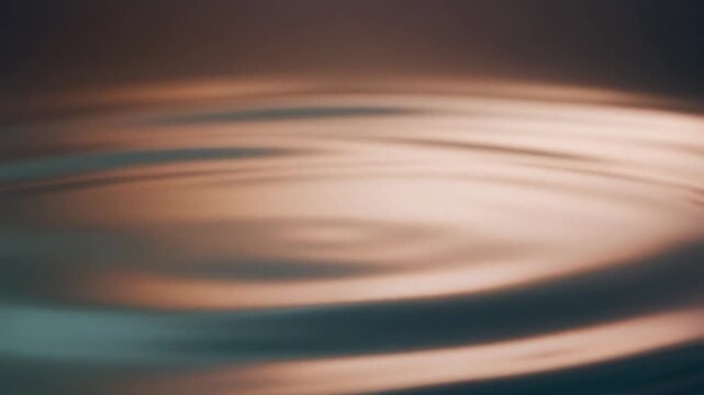 Close up of liquid ripples, water waves, abstract fluid motion, bronze and blue tones