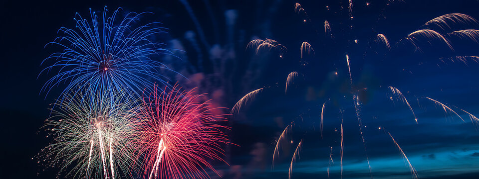 Vibrant fireworks display illuminates dark night sky with streaks of red white and blue light symbolizing celebration freedom and patriotism in stunning visual spectacle for holidays.