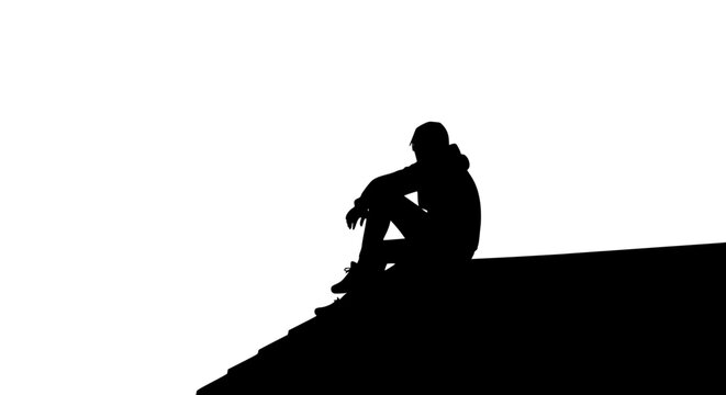 Silhouette of a lonely person sitting on a roof ledge against white background