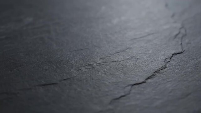 Abstract dark gray stone texture background with natural cracked surface.