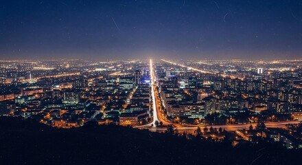 Obraz premium Stunning Aerial Night View of a Bustling Urban Cityscape.