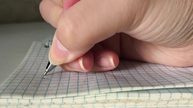 The hand uses a pen to write the numbers in the notebook. Accounting, accounting. A woman counts expenses, dead. Payment of taxes