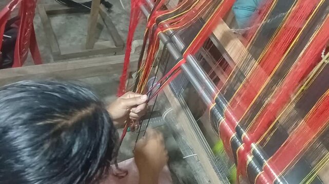 Handloom weaver in India working in her loom.