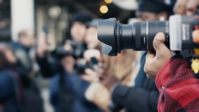 Paparazzi photographers taking pictures at a celebrity event