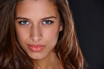 Naklejka premium Woman, makeup and beauty in studio portrait, glow and transformation with lipgloss by black background. Girl, person and model with pout, lipstick and facial cosmetics with confidence in Italy