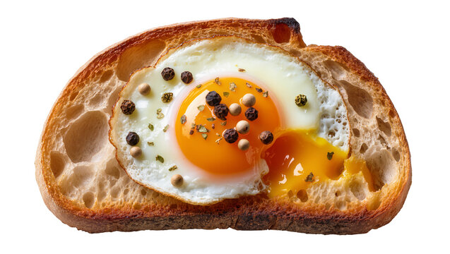 Fried egg with runny yolk on toasted sourdough bread seasoned with peppercorns, isolated on transparent background