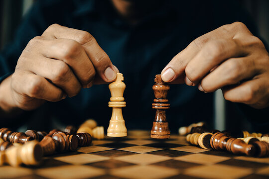 Hand choose King chess on falling chess concept of business strategy plan and leadership or wining challenge and team player and risk management or human resource or strategic planning.