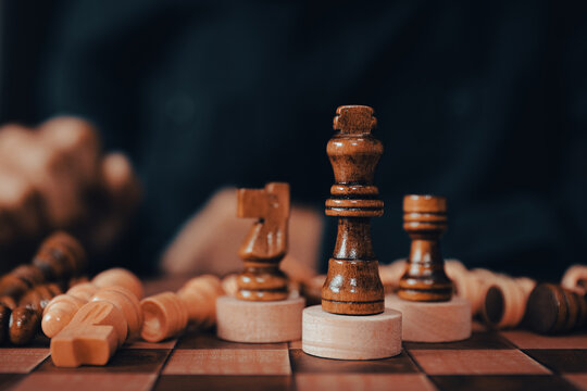 King chess on falling chess concept of business strategy plan and leadership or wining challenge and team player and risk management or human resource or strategic planning.
