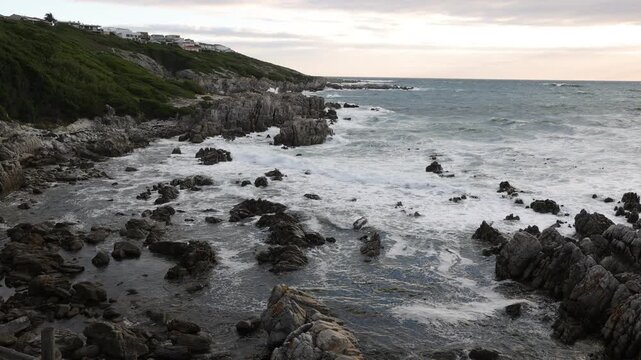 stormy sea meeting rocky coastline of DeKelders, South Africa