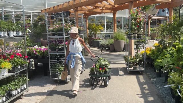 woman at garden center buying flowers for her garden