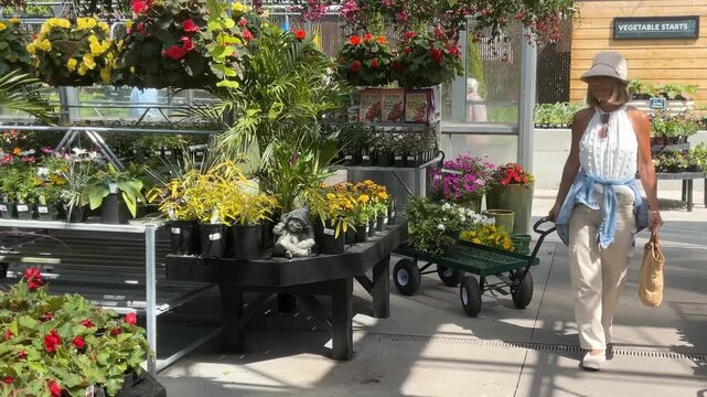 woman at garden center buying flowers for her garden
