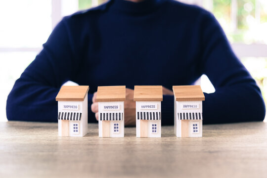 Hand chooses wooden franchise business store for franchising to growth branch expansion and business banking loan or consumer resources service.