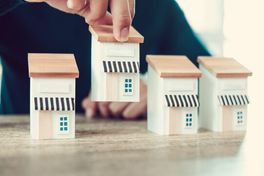 Hand chooses wooden franchise business store for franchising to growth branch expansion and business banking loan or consumer resources service.