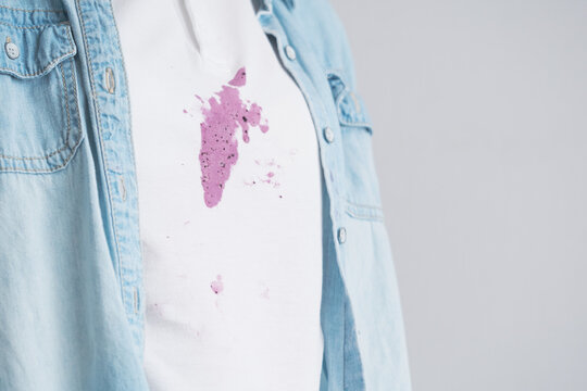 Spilled ice cream on white clothes of an unidentified person. Concept of daily stains on clothes. 